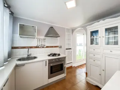 a kitchen with white cabinets and a sink at Al 13 - La Terrazza in Rome