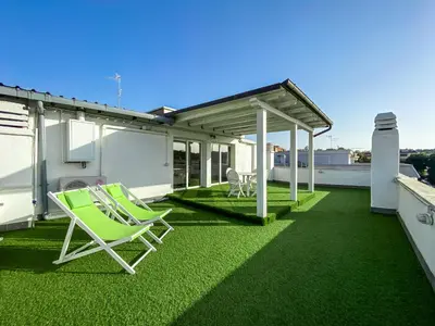 a patio with two lawn chairs and a roof at Al 13 - La Terrazza in Rome