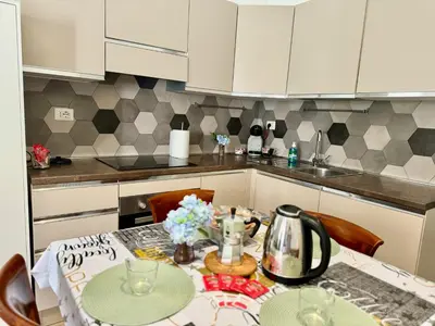 a kitchen with a table with a tea pot on it at Dreams in Rome Vaticano - Metro A in Rome