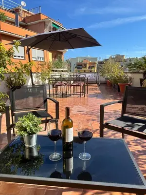 a table with two glasses and a bottle of wine at Casa Mapi in Rome