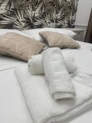 a bed with two towels and pillows on it at Bobbio Holiday Rome in Rome