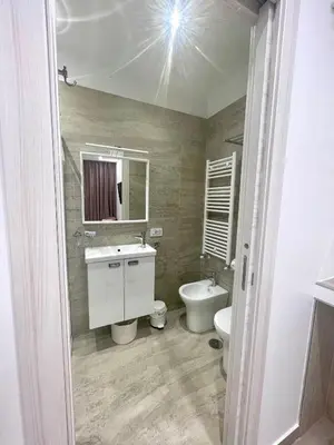 a bathroom with a sink and a toilet and a mirror at Bobbio Holiday Rome in Rome