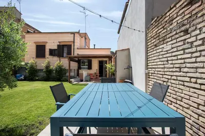 a blue table in the backyard of a house at Giardino al 9 in Rome