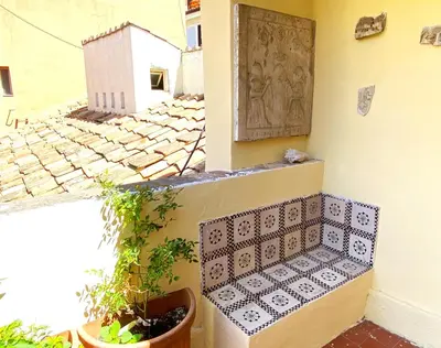 a bench sitting on the side of a building at Terraces under the Moon in Rome