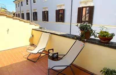 two chairs sitting on the balcony of a building at Terraces under the Moon in Rome
