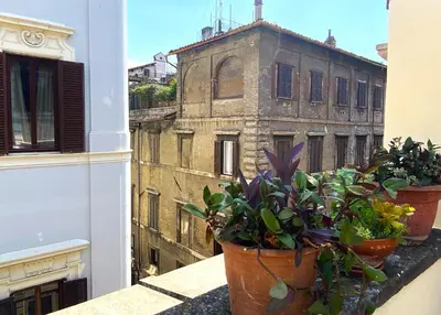 two potted plants on a balcony with an old building at Terraces under the Moon in Rome