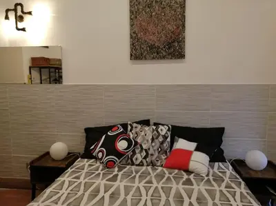 a bedroom with a bed with pillows on it at Trastevere Home Gallery in Rome