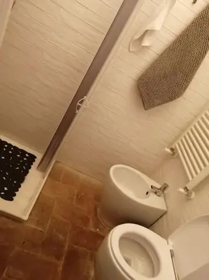 a bathroom with a toilet and a bidet at Trastevere Home Gallery in Rome