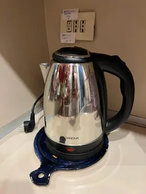 a tea kettle sitting on top of a counter at 2 Bedroom Flat at just 4 tube stops from Coliseum in Rome