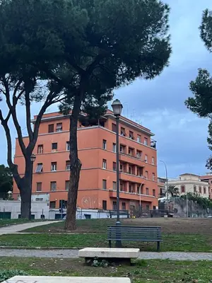 a park with a bench in front of a building at 2 Bedroom Flat at just 4 tube stops from Coliseum in Rome