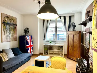 a living room with a blue couch and a table at 2 Bedroom Flat at just 4 tube stops from Coliseum in Rome