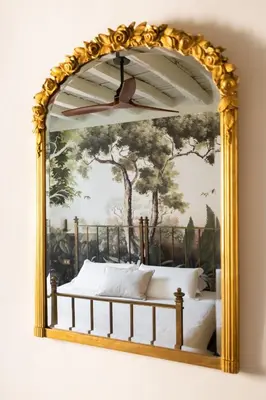 a mirror on a wall with a bed in it at Charming Design Apartment in Monti in Rome