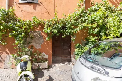 a scooter parked in front of a building with a door at Charming Design Apartment in Monti in Rome