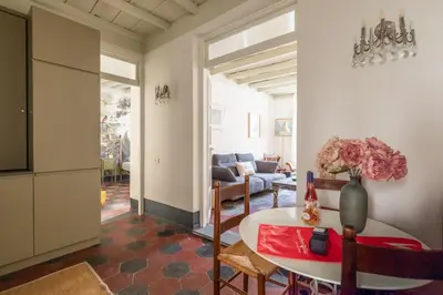 a living room with a table and a couch at Charming Design Apartment in Monti in Rome