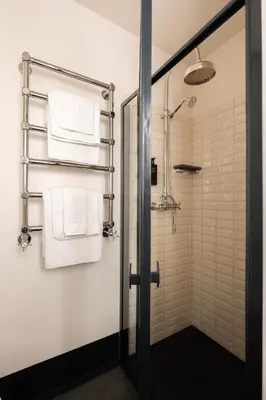a bathroom with a shower and white towels at Charming Design Apartment in Monti in Rome