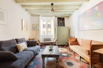 a living room with a couch and a table at Charming Design Apartment in Monti in Rome