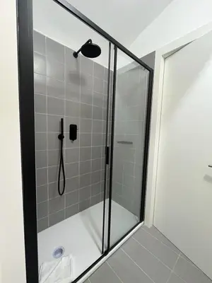 a shower with a glass door in a bathroom at Youroom Monteverde - Rooms in Rome