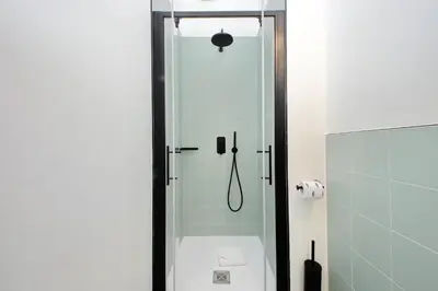 a bathroom with a shower with a glass door at Youroom Monteverde - Rooms in Rome