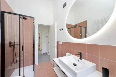 a bathroom with a sink and a mirror at Youroom Monteverde - Rooms in Rome