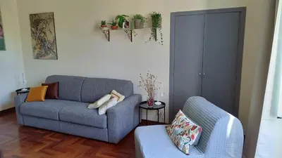 a living room with a couch and a chair at Quiet in Biancamano - Metro A - San Giovanni - Centro Storico in Rome
