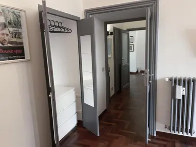a room with a hallway with a mirror and a door at Quiet in Biancamano - Metro A - San Giovanni - Centro Storico in Rome