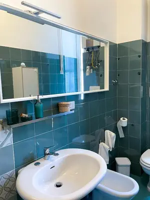 a bathroom with a sink and a toilet and a mirror at Quiet in Biancamano - Metro A - San Giovanni - Centro Storico in Rome