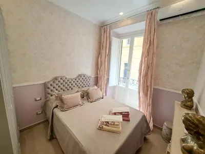 a bedroom with a large bed with a window at Suite della Vite 27 in Rome