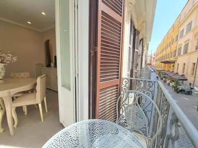 a balcony with chairs and a table on a balcony at Suite della Vite 27 in Rome