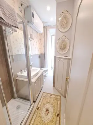 a bathroom with a shower and a sink and a toilet at Suite della Vite 27 in Rome