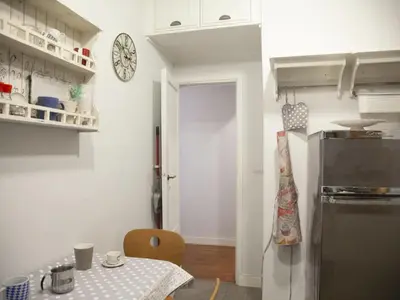 a kitchen with a table and a refrigerator in it at Apartment Testaccio Piramide by Interhome in Rome