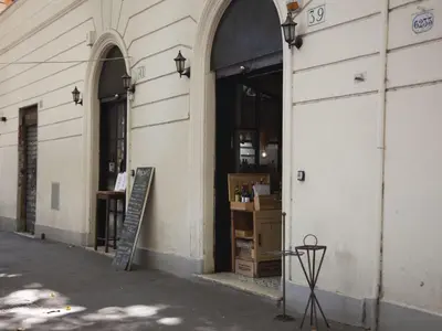 a store with a chalkboard in the doorway of a building at Apartment Testaccio Piramide by Interhome in Rome