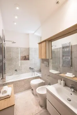 a bathroom with a toilet and a tub and a sink at ROMA your home in trastevere e gianicolo in Rome