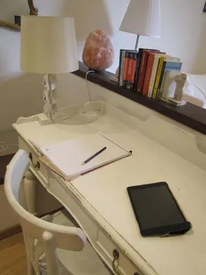 a desk with a lamp and a tablet on it at ROMA your home in trastevere e gianicolo in Rome