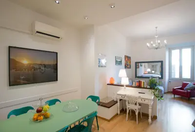 a living room with a table and a dining room at ROMA your home in trastevere e gianicolo in Rome