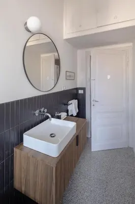 a bathroom with a white sink and a mirror at New apartment with amazing view of S Peter's Dome in Rome