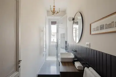a bathroom with a sink and a mirror at New apartment with amazing view of S Peter's Dome in Rome