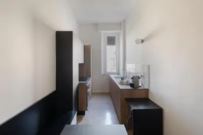 a small kitchen with a black and white room at New apartment with amazing view of S Peter's Dome in Rome