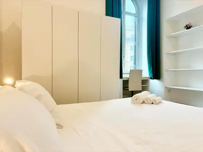 a bedroom with a white bed with towels on it at DaliTourism - Vatican Apartment 193 in Rome