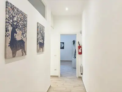 a hallway with paintings on the walls of a room at DaliTourism - Vatican Apartment 193 in Rome