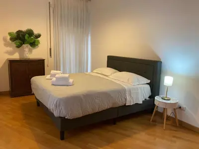 a bedroom with a large bed with towels on it at FAIROME Apartment 2 Pini in Rome