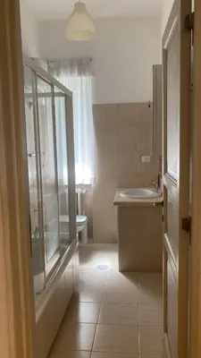 a bathroom with a shower and a sink and a toilet at FAIROME Apartment 2 Pini in Rome