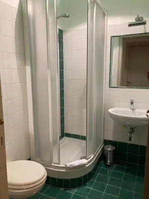 a bathroom with a shower and a toilet and a sink at FAIROME Apartment 2 Pini in Rome