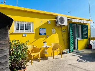 a yellow house with a table and chairs in front of it at Terrazza Gianicolense in Rome
