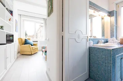 a bathroom with a white door and a sink at Comfortable Dream Apartment Piazza del Popolo in Rome