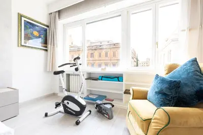 a living room with a couch and a exercise bike at Comfortable Dream Apartment Piazza del Popolo in Rome