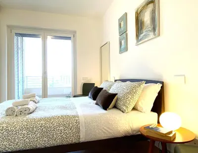 a bedroom with a bed with pillows and a window at Olmocolmo Trastevere in Rome