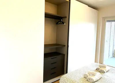 a bedroom with a mirror and a bed with towels at Olmocolmo Trastevere in Rome