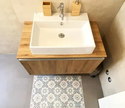 a bathroom with a white sink on a wooden vanity at Olmocolmo Trastevere in Rome