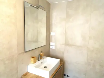 a bathroom with a white sink and a mirror at Olmocolmo Trastevere in Rome