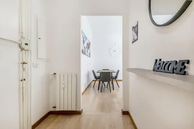 a dining room with a table and a mirror at Tiburtina White House in Rome